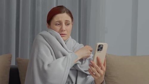 Woman Wrapped in Blanket Video Calling on Smartphone