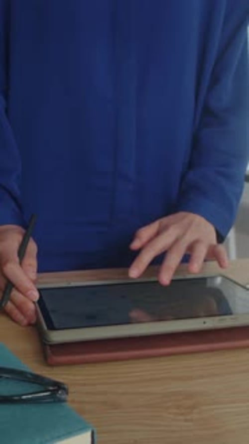 Vertical of Analyst Working on Report Using Digital Tablet
