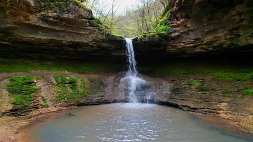 Drone view of cascade waterfall in Saharna Monastery, Moldova. Forest and cave