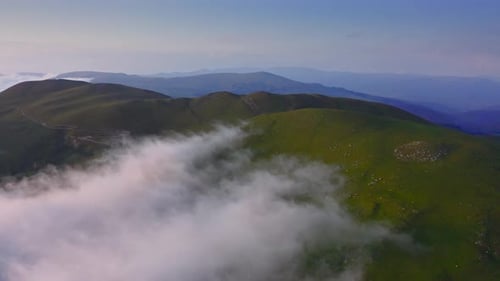 Clouds Creeping Over The Mountain Plateau At Dawn, Drone Aerial Shot