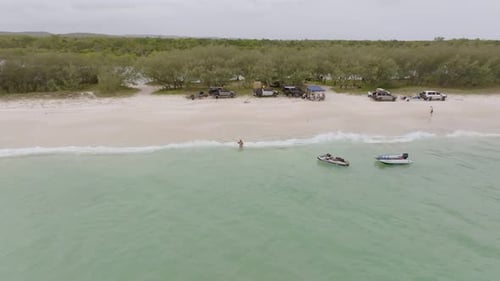 Aerial view of beach and ocean with vehicles, Australia.
