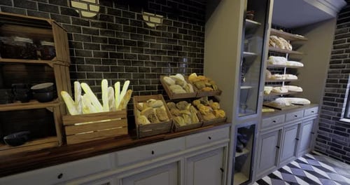 A Cozy Bakery Features Wooden Shelves Filled with Assorted Breads and Pastries