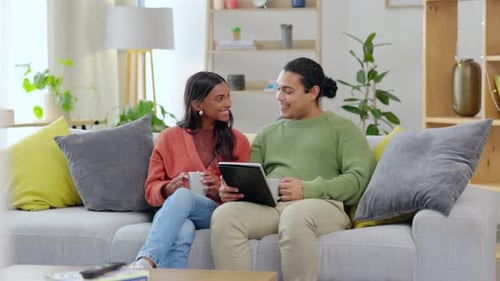 Couple Relaxing with Tablet and Drinks at Home