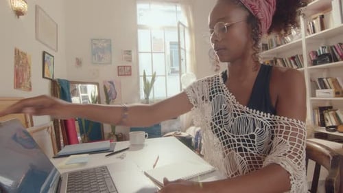 African-American Girl Opening Laptop and Typing at Home Workplace