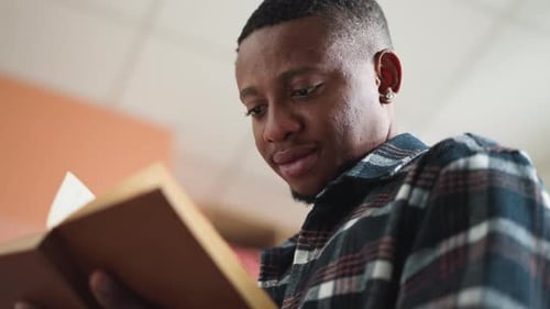 Darkskinned Man Learns Literature in Library