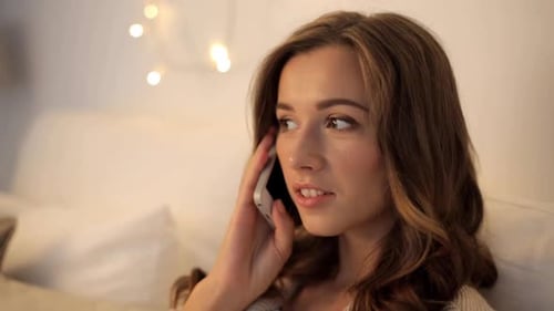 Attractive Woman Chatting on Mobile Phone Indoors