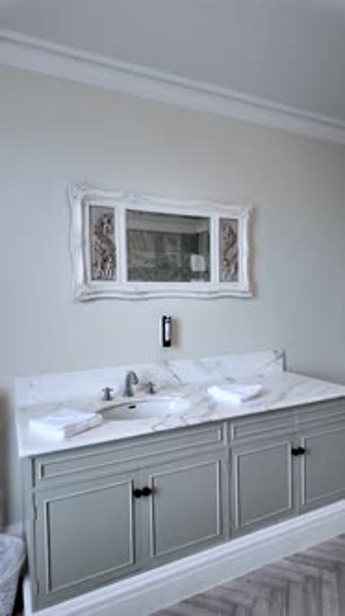 Bathroom Vanity With Marble Countertop Gray Cabinets White Sink Faucet Towels And Ornate Mirror For