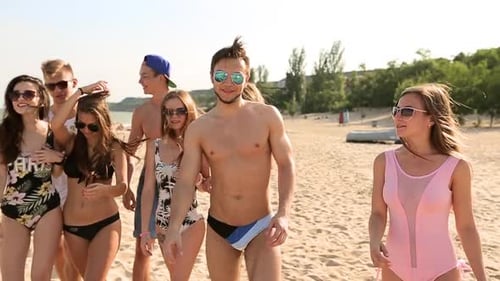 Group of Friends Walking on Sunny Beach Young Tanned Cheerful Caucasian People Walking Chatting and