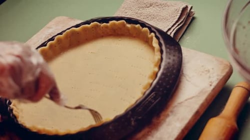 Pie Crust Preparation with Fork and Gloves