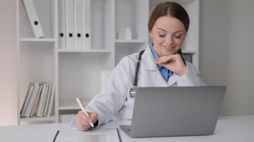 Female Doctor Working at Her Desk in Office