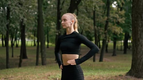 Close-up of a girl in sportswear bends to different sides to stretch her back muscles lifestyle