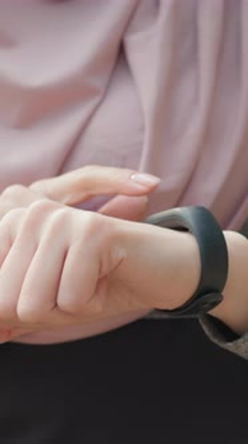 Woman Using Fitness Tracker on Wrist