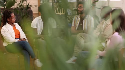 Adults Talking Together in Friendly Indoor Group