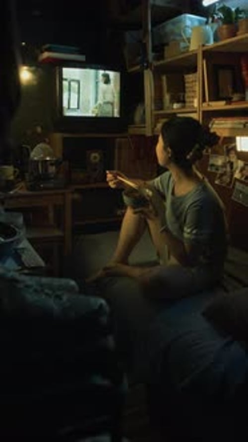 Korean Girl Eating Stir-Fry and Watching TV Commercial in Micro Flat