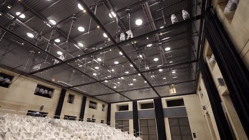 Entering Empty Theater Hall with a view on Tension Wire Grid Ceiling