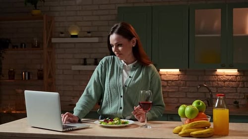 Woman at the Table in the Kitchen Preparing Healthy Vegetable Salad for Dinner Woman Eating Fresh