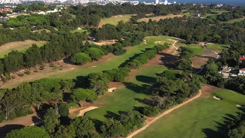 Aerial Shot of a Beautiful Golf Course Surrounded By Trees and Greenery