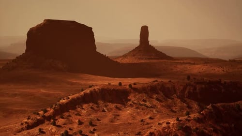 Une majestueuse formation rocheuse se dressant haut dans le vaste paysage désertique