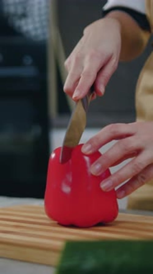 Close Up Unknown Woman Cutting on Pepper with Knife on Cutting Board When Preparing Vegetable Salad