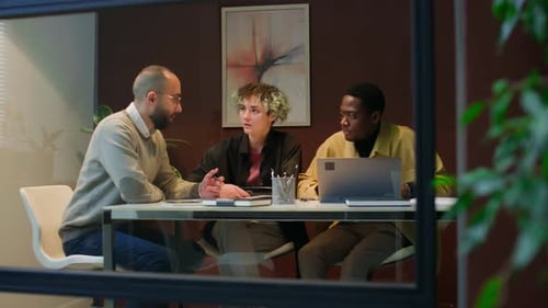 Manager Discussing Business Plan with Two Diverse Coworkers in Office