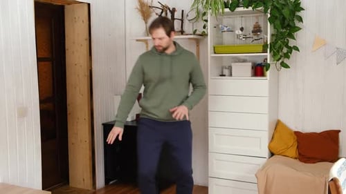 Man Dancing and Gesturing Indoors