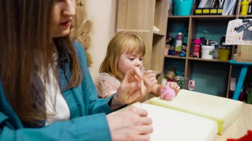 Child Enjoying Arts and Crafts Activity at Local Creative Workshop