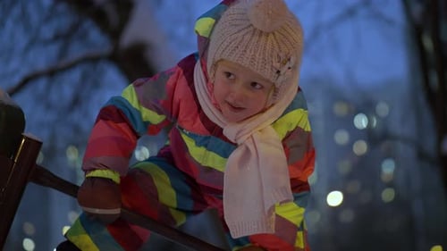 Active Child on Playground in Winter Evening