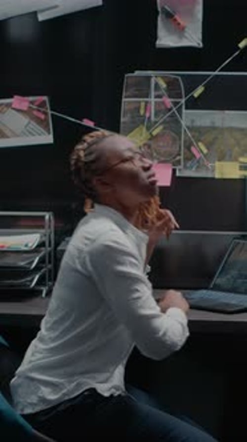 Vertical Video Law Officer Checking Forensic Evidence in Police Office