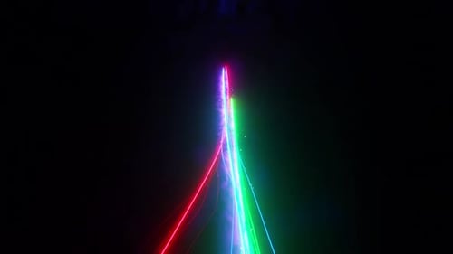 Vibrant neon light streaks illuminate dark space with dynamic energy