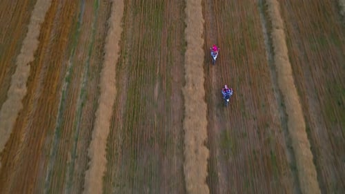 Motocross meadow riding. Bike extreme countryside traveling aerial view.