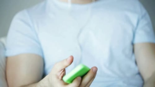 Technology, People and Lifestyle Concept - Close Up of Man with Smartphone