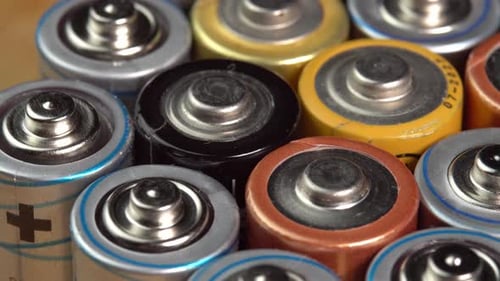 Rows of used alkaline AA batteries. Lithium ion battery pack close up. Electric power supply