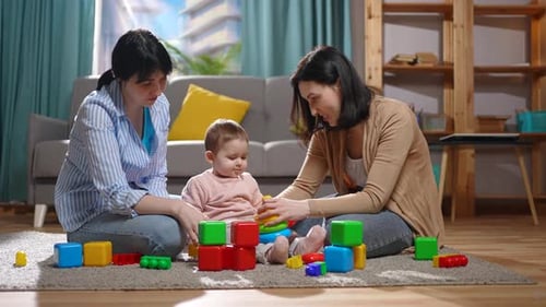 Baby Plays with Toys with Family at Home