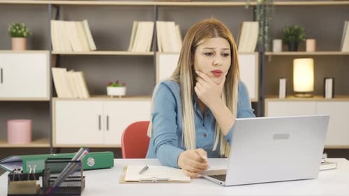 Young Woman Working on Laptop in Office