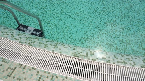 Staircase Made of Steel Railing to Enter the Blue Water of the Pool in the Hotel Villa