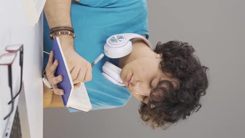 Student Writing in Notebook at Bright Desk
