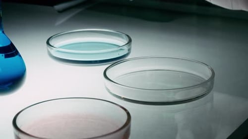 Scientist uses pipette in lab to drop liquid