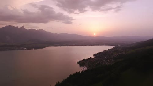 Peaceful mountain lake at sunset with scenic sky