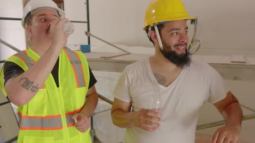 Construction Workers Taking a Break Together Drinking Water