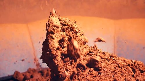 Brown Soil Being Dropped