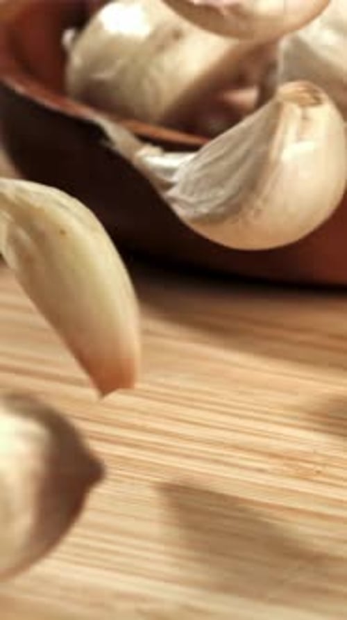 Fresh Garlic Falls on a Cutting Board Filmed on a Highspeed Camera at 1000 Fps