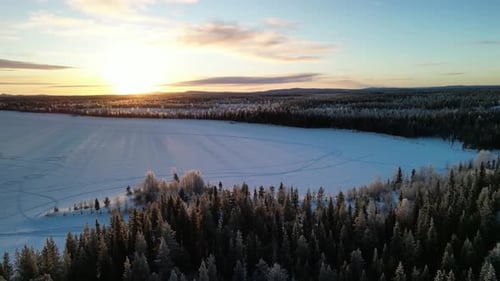 Aerial view of winter landscapes with snow-covered forest in Finland