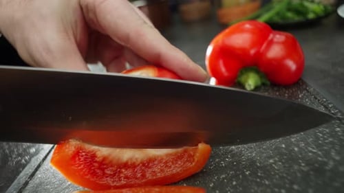 Slicing Red Pepper on Cutting Board Close Up