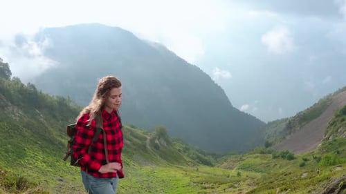 Pretty Woman Walks Along Way on Mountain Top in Green Valley