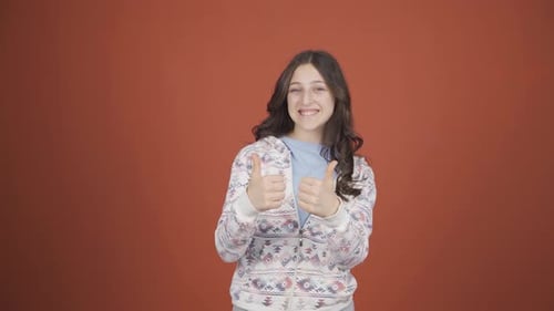 Girl Gives Two Thumbs Up With a Smile