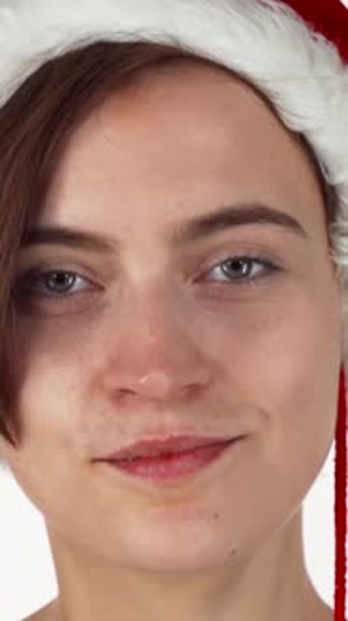 Surprised Young Woman in a Festive Santa Hat
