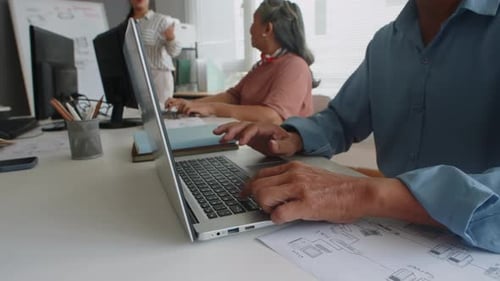 People Working on Computers in Modern Office