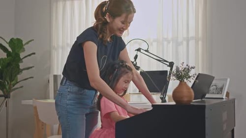 Child Learning Piano with Adult at Home