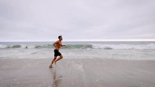 Athletic Man Exercising At The Beach