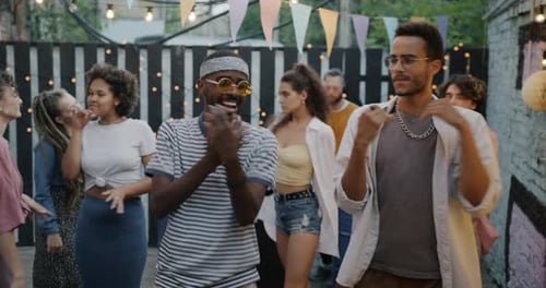 Friends Dancing Together at an Outdoor Urban Party